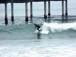 surfer near pier
