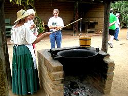 woman demonstrates how candles are made