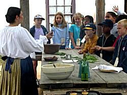 children watch as food preperation is demonstrated
